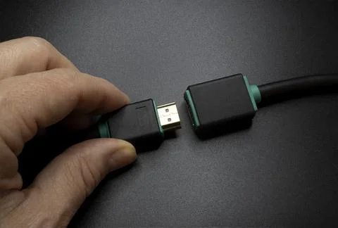 Connecting an HDMI Cable isolated on gray background Stock Photos