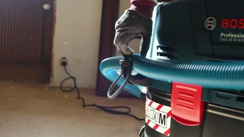 Connecting Hose to Bosch Vacuum in Workshop Stock Footage 303868143