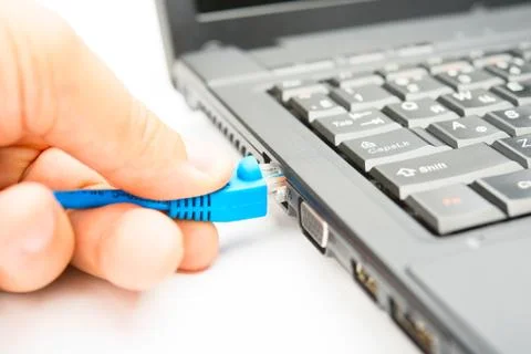 Connecting of internet cable to the notebook Stock Photos