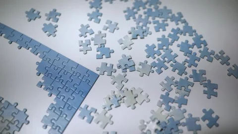 Connecting jigsaw puzzle pieces, fun family activity Stock Footage 316987018