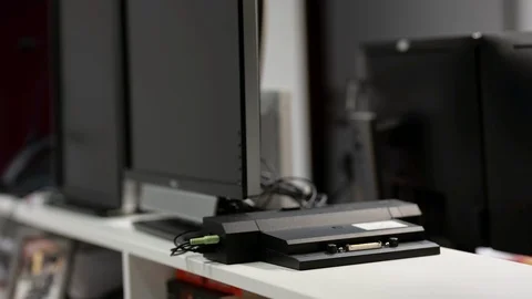 Connecting a laptop to its docking station, 2 monitors setup Stock Footage 122052711