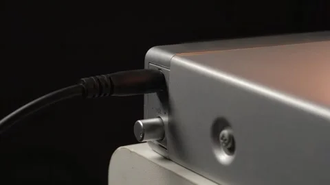 Connecting a microphone to a mini-jack, connecting a phone to a mini-power jack Stock Footage 265013631