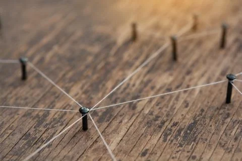 Connecting networks concept - network connected with yarn white on Plank wood Stock Photos