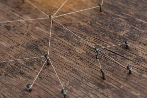 Connecting networks concept - network connected with yarn white on Plank wood Stock Photos