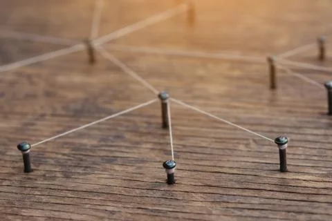 Connecting networks concept - network connected with yarn white on Plank wood Stock Photos