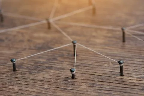 Connecting networks concept - network connected with yarn white on Plank wood Foto stock