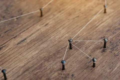 Connecting networks concept - network connected with yarn white on Plank wood Stock Photos