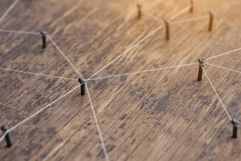 Connecting networks concept - network connected with yarn white on Plank wood Stock Photos