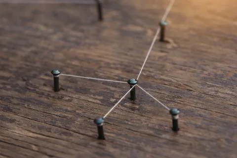 Connecting networks concept - network connected with yarn white on Plank wood Stock Photos