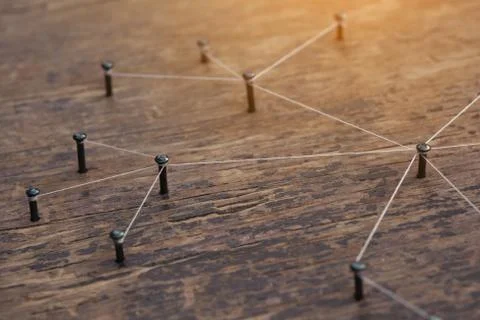 Connecting networks concept - network connected with yarn white on Plank wood Stock Photos
