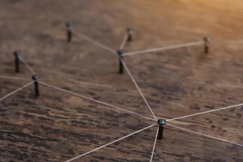 Connecting networks concept - network connected with yarn white on Plank wood Stock Photos