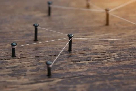 Connecting networks concept - network connected with yarn white on Plank wood Stock Photos