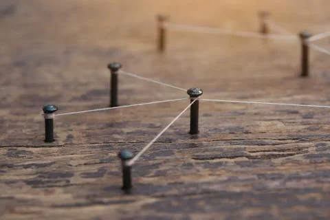 Connecting networks concept - network connected with yarn white on Plank wood Stock Photos