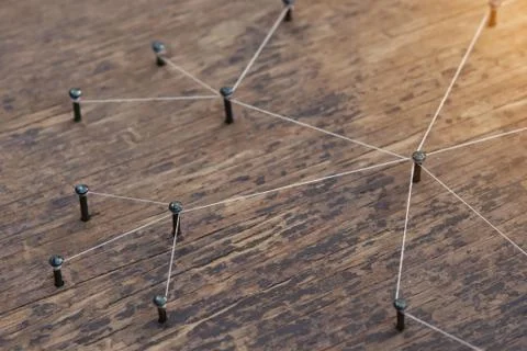 Connecting networks concept - network connected with yarn white on Plank wood Stock Photos