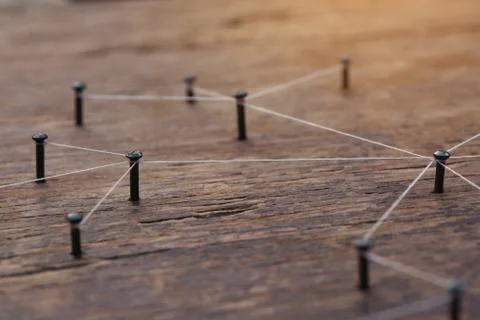 Connecting networks concept - network connected with yarn white on Plank wood Stock Photos