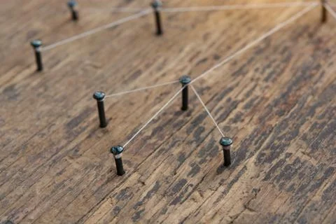 Connecting networks concept - network connected with yarn white on Plank wood Stock Photos