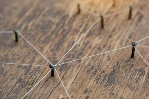 Connecting networks concept - network connected with yarn white on Plank wood Stock Photos