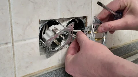 Connecting a new wall socket to electrical wires Stock Footage 312396615