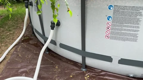 Connecting a Pool Pump to a Large Inflatable Pool Stock Footage 279248321