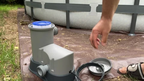 Connecting a Pool Pump to a Large Inflatable Pool Stock Footage 279248482