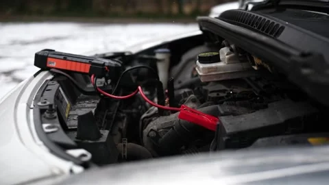 Connecting Portable Jump Starter Battery Device To Engine With Low Battery Video stock 329226793