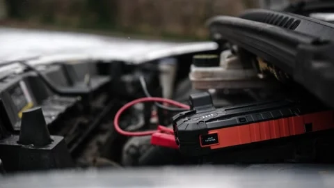 Connecting Portable Jump Starter Battery Device To Engine With Low Battery Video stock 329226830