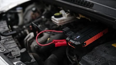 Connecting Portable Jump Starter Battery Device To Engine With Low Battery Stock Footage 341575385