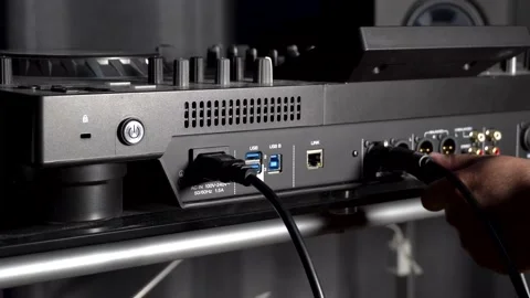Connecting power and XLR cables to DJ mixer Stock Footage 201984316