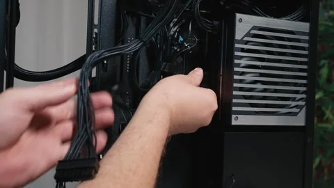 Connecting power cable to modular power supply unit during PC assembly Stock Footage 325809709