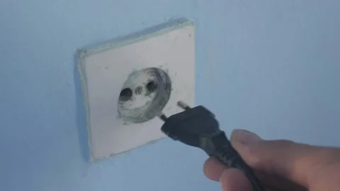 Connecting power cable to old fashioned socket 4K video Stock Footage 139478220