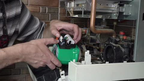 Connecting the pump in the boiler Stock Footage 208909349