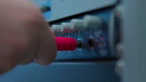 Connecting a red plug to the soundbar on a desk Stock Footage 335561077