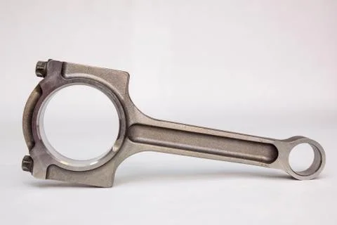 Connecting rod from a car engine isolated on white. Stock Photos
