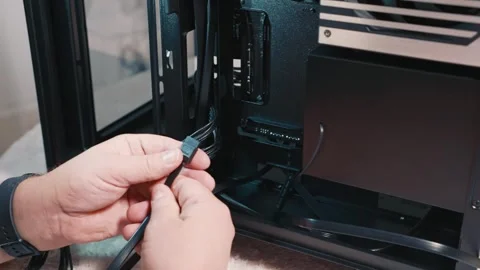 Connecting SATA cable to SSD drive inside PC case Stock Footage 325809991