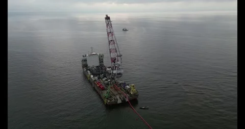 Connecting a seacable from a windpark to an onshore power hub Stock Footage 291339182