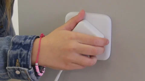 Connecting smart plug into a house outlet to control an electrical device Stock Footage 153489294