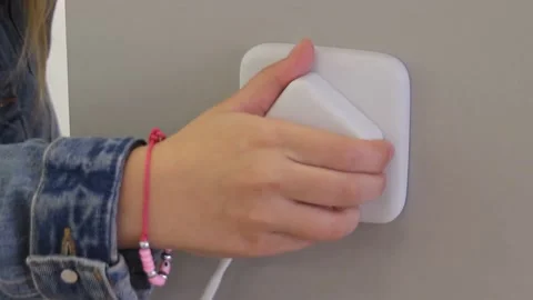 Connecting smart plug into a house outlet to control an electrical device with t Stock Footage 154424013