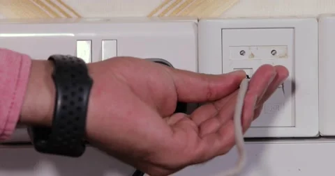 Connecting telephone cable to jack fixed on the wall Stock Footage 146730693