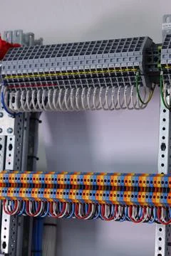 Connecting through-pass electrical terminals in the electrical panel Stock Photos