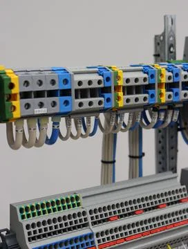 Connecting through-pass electrical terminals in the electrical panel Stock Photos