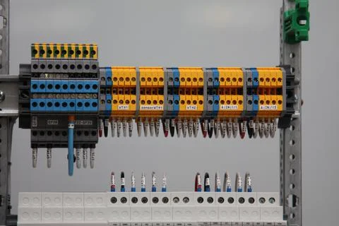 Connecting through-pass electrical terminals in the electrical panel Stock Photos