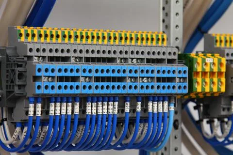 Connecting through-pass electrical terminals in the electrical panel Stock Photos