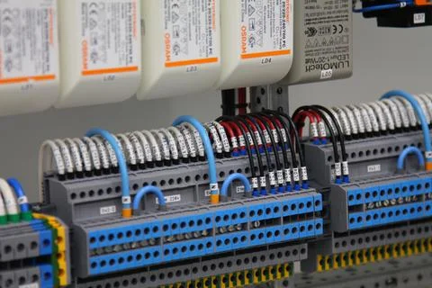 Connecting through-pass electrical terminals in the electrical panel Stock Photos