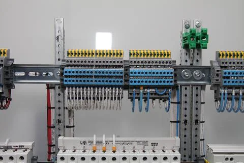 Connecting through-pass electrical terminals in the electrical panel Stock Photos
