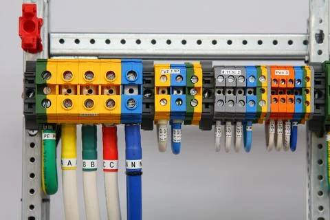 Connecting through-pass electrical terminals in the electrical panel Stock Photos
