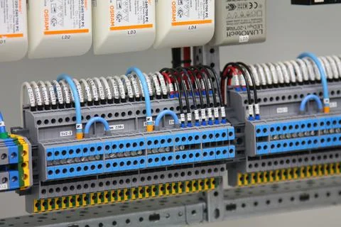Connecting through-pass electrical terminals in the electrical panel Stock Photos