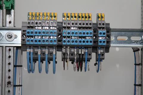 Connecting through-pass electrical terminals in the electrical panel Stock Photos