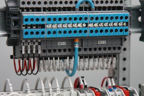 Connecting through-pass electrical terminals in the electrical panel Stock Photos