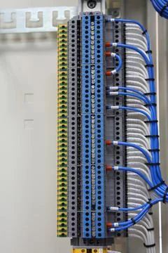 Connecting through-pass electrical terminals in the electrical panel Stock Photos