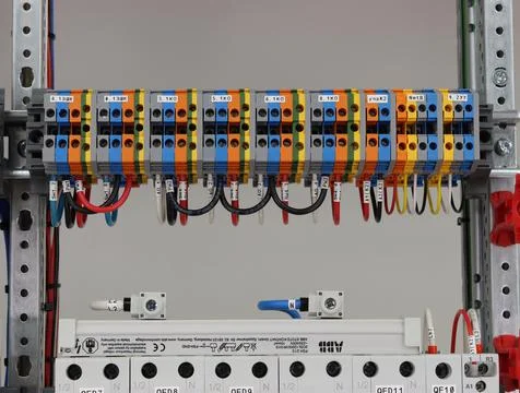 Connecting through-pass electrical terminals in the electrical panel Stock Photos